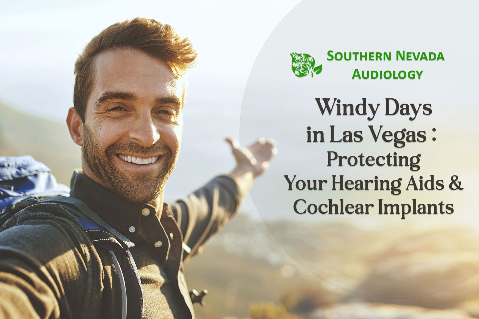 happy man in windy mountains taking selfie.