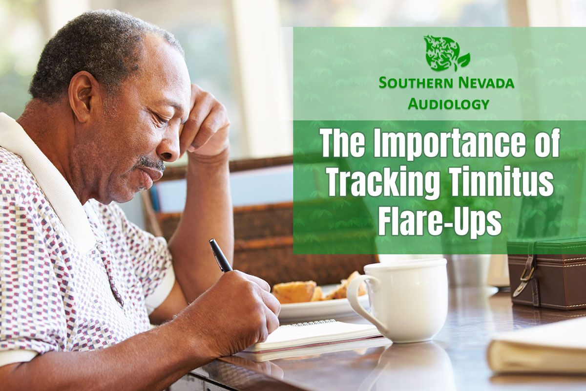 man writing down his tinnitus flare-ups.