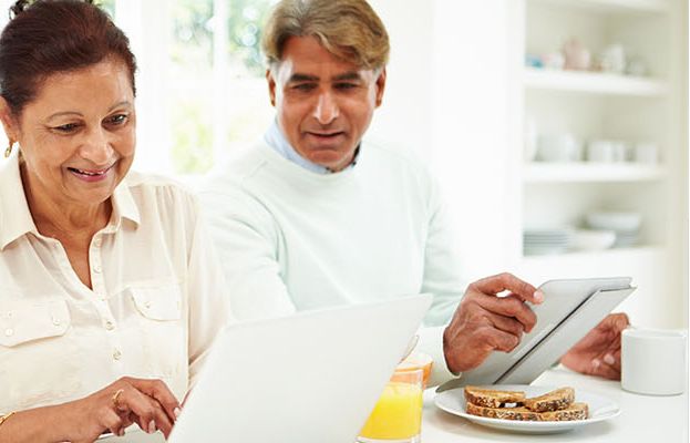 Couple reading about hearing health together at home