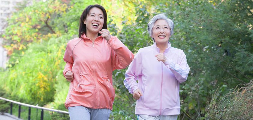 Two women walking outdoors together, staying active and connected