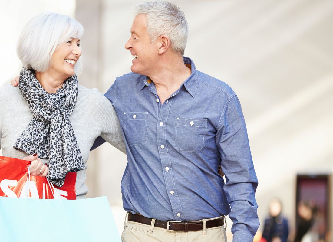 Smiling couple in Las Vegas enjoying conversation — one of them wears a nearly invisible hearing aid
